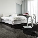 Pristine flooring is a foil for this white bedroom suite. Space and light emphasise the elegant modernism.